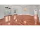 Light filled living room with hardwood floors, chandelier, and transom window at 6205 Ibispark Dr, Lithia, FL 33547