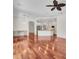 Bright living room boasts wood floors and recessed lighting, adjacent to a modern kitchen area at 6205 Ibispark Dr, Lithia, FL 33547
