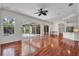 Spacious living room features hardwood floors, a ceiling fan, and access to the outdoor patio at 6205 Ibispark Dr, Lithia, FL 33547