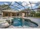A screened-in pool and patio area adjacent to a modern home's rear exterior at 6205 Ibispark Dr, Lithia, FL 33547