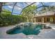 A screened-in pool with a spa surrounded by mature landscaping and sky view at 6205 Ibispark Dr, Lithia, FL 33547