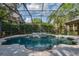 Screened in pool and spa offers a private retreat with lush landscaping in a backyard oasis at 6205 Ibispark Dr, Lithia, FL 33547