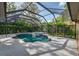 Enclosed pool and spa offers a private retreat in a backyard oasis and lush landscaping at 6205 Ibispark Dr, Lithia, FL 33547