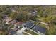 An aerial view showing the neighborhood, fence lines, driveways, and houses with dark roofing and white walls at 6302 N 39Th St, Tampa, FL 33610