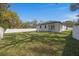 Wide backyard features a lush lawn and white fence, perfect for outdoor activities at 6302 N 39Th St, Tampa, FL 33610