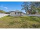 Spacious backyard with lush green grass, fenced perimeter, and mature trees at 6302 N 39Th St, Tampa, FL 33610