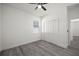 Bedroom featuring gray wood-look floors, a ceiling fan, closet with double doors, and a window at 6302 N 39Th St, Tampa, FL 33610