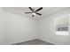 Bright bedroom with a ceiling fan, window with blinds, and attractive gray wood-look flooring at 6302 N 39Th St, Tampa, FL 33610