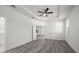 Bedroom with wood-look floors and a ceiling fan, with a view into an adjacent room at 6302 N 39Th St, Tampa, FL 33610