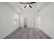 Bedroom featuring wood-look floors, a ceiling fan, and two closets at 6302 N 39Th St, Tampa, FL 33610