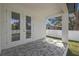 Cozy covered patio with tiled flooring and French doors leading to backyard at 6302 N 39Th St, Tampa, FL 33610