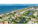 Aerial shot captures a waterfront home with a pool, lush landscaping, and boat docks along the canal at 6317 Marbella Blvd, Apollo Beach, FL 33572