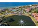 Beautiful community pond with a fountain, playground, and tennis courts amid waterfront homes and palm trees at 6317 Marbella Blvd, Apollo Beach, FL 33572