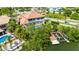 Aerial view of house with pool, boat lift, and lush landscaping at 6317 Marbella Blvd, Apollo Beach, FL 33572