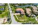 Beautifully landscaped property with a well-maintained lawn, red roof, and a circular driveway lined with palm trees at 6317 Marbella Blvd, Apollo Beach, FL 33572