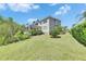 Lush backyard with healthy lawn and landscaping, complemented by the home's exterior at 6317 Marbella Blvd, Apollo Beach, FL 33572