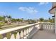 Balcony with decorative railing overlooking palm tree lined street and neighborhood at 6317 Marbella Blvd, Apollo Beach, FL 33572