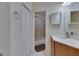 Well-lit bathroom with a shower, vanity, mirrored cabinet, and tile flooring at 6317 Marbella Blvd, Apollo Beach, FL 33572
