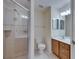 The bathroom has neutral tile, a glass enclosed shower, and a single sink vanity at 6317 Marbella Blvd, Apollo Beach, FL 33572