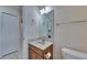 Cozy bathroom featuring a wood vanity, framed mirror, updated lighting, and a toilet at 6317 Marbella Blvd, Apollo Beach, FL 33572