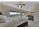 Spacious bedroom includes large windows, a fireplace, and a ceiling fan for comfortable living at 6317 Marbella Blvd, Apollo Beach, FL 33572