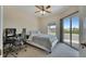 Comfortable bedroom boasts natural light, a ceiling fan, and access to a private balcony with scenic views at 6317 Marbella Blvd, Apollo Beach, FL 33572