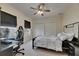Well-lit bedroom featuring a modern bed, desk, gaming chair and dual closets at 6317 Marbella Blvd, Apollo Beach, FL 33572
