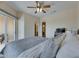 Bright bedroom featuring neutral colors, a ceiling fan, and sliding glass doors leading to outdoor space at 6317 Marbella Blvd, Apollo Beach, FL 33572