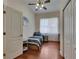 Well-lit bedroom showcasing hardwood floors, a twin bed, sheer curtains, and a closet at 6317 Marbella Blvd, Apollo Beach, FL 33572