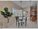 Cozy breakfast nook with windows, and glass table with chairs, filled with natural light at 6317 Marbella Blvd, Apollo Beach, FL 33572