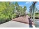 Wide dock area with built-in seating providing beautiful water views and lush foliage at 6317 Marbella Blvd, Apollo Beach, FL 33572