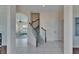 Open-concept foyer with staircase leading to the upper level, and access to the living area at 6317 Marbella Blvd, Apollo Beach, FL 33572