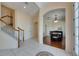Inviting foyer with staircase, white tile flooring, and arched entryway to dining room at 6317 Marbella Blvd, Apollo Beach, FL 33572