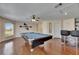 Entertainment room with a pool table, bar stools, gleaming hardwood floors, and a ceiling fan at 6317 Marbella Blvd, Apollo Beach, FL 33572