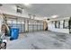Spacious three car garage featuring updated garage doors with openers and access to a staircase at 6317 Marbella Blvd, Apollo Beach, FL 33572