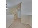 Neutral hallway with carpet and baseboard trim, illuminated by overhead lighting at 6317 Marbella Blvd, Apollo Beach, FL 33572
