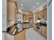 Well lit kitchen features stainless appliances, granite countertops and light wood cabinets at 6317 Marbella Blvd, Apollo Beach, FL 33572