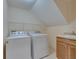 Functional laundry room with washer, dryer, sink, and overhead shelving at 6317 Marbella Blvd, Apollo Beach, FL 33572