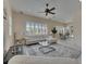 Open living room featuring a ceiling fan and plantation shutters for natural light at 6317 Marbella Blvd, Apollo Beach, FL 33572