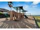 Community playground equipment with slides, ladders, and a swing set overlooks a calm ocean backdrop at 6317 Marbella Blvd, Apollo Beach, FL 33572