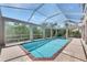 Screened-in pool features a spa and a brick-paved deck at 6317 Marbella Blvd, Apollo Beach, FL 33572