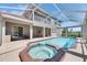 Backyard features a screened in pool and hot tub perfect for entertaining at 6317 Marbella Blvd, Apollo Beach, FL 33572