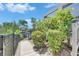 Inviting walkway with lush greenery leading to waterfront access on a sunny day at 6317 Marbella Blvd, Apollo Beach, FL 33572