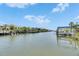 Picturesque waterfront view along the canal with boat docks under a blue sky with scattered clouds at 6317 Marbella Blvd, Apollo Beach, FL 33572