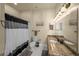 Cozy bathroom with granite countertop vanity, neutral walls, and shower with black and white curtain at 700 S Harbour Island Blvd # 813, Tampa, FL 33602