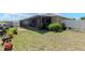 Backyard with grass, potted plants and screened in lanai at 7019 Wiseman Run Dr, Sun City Center, FL 33573