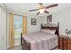 Comfortable bedroom features a ceiling fan, neutral paint and a decorative wood bed frame with soft bedding at 7019 Wiseman Run Dr, Sun City Center, FL 33573
