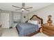 This comfortable bedroom has a ceiling fan, dresser and a full sized bed with soft bedding at 7019 Wiseman Run Dr, Sun City Center, FL 33573