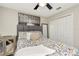 Comfortable bedroom features a ceiling fan, closet and a decorative painting over the full sized bed at 7019 Wiseman Run Dr, Sun City Center, FL 33573