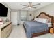 This comfortable bedroom has a ceiling fan, dresser and a full sized bed with soft bedding at 7019 Wiseman Run Dr, Sun City Center, FL 33573